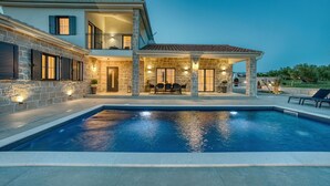 A two-story house with a swimming pool, stone exterior, and outdoor seating area. - Luxury Villa Oliva Oliana heated pool 32m2, bbq, family (Vrsi)