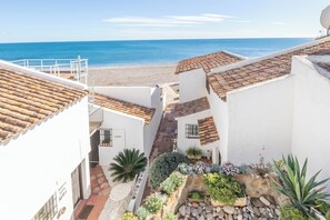 Guests can enjoy a Mediterranean-style retreat with a garden leading to the beach and a scenic sea view.