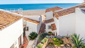 A coastal building with terracotta roofs, a white exterior, and a view of the sea. - Bahia Dorada Beach (Estepona)