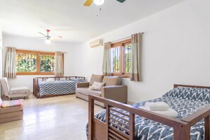 A room with a bed, a sofa, a chair, and a window with curtains. - Villa Calahonda 700m From Beach With Pool (Mijas)