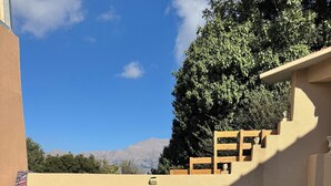 A pool area with a view of mountains, a wooden deck, and a towel on a white surface. - Classic 3-bedrooms apartment with swimming pool in Meronas (Meronas)