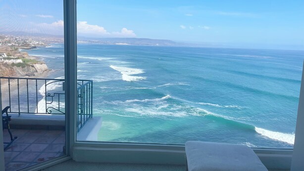 A balcony with a view of the ocean and a distant coastline. - Amazing OCEANFRONT Views! 2HUGE Rosarito Condos/Entire Floor! Priv Beach SurfK38 (Playas de Rosarito)