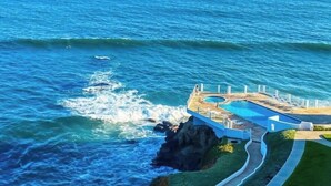 A coastal property with a pool, lounge chairs, and a view of the ocean. - Amazing OCEANFRONT Views! 2HUGE Rosarito Condos/Entire Floor! Priv Beach SurfK38 (Playas de Rosarito)