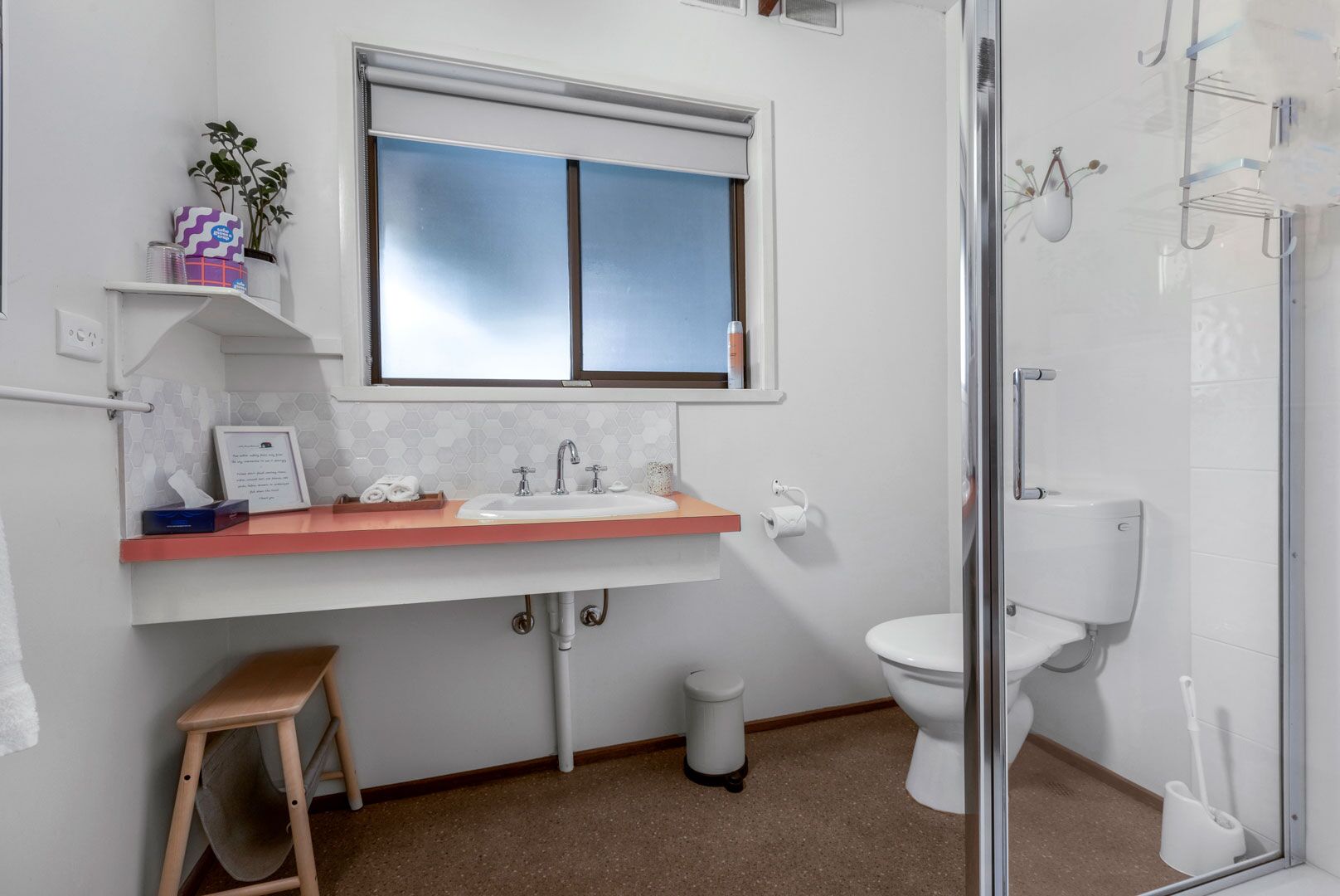 A bathroom with a sink, toilet, and shower.