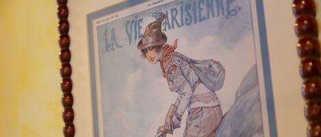 Póster antiguo con una figura de sombrero y un pico, rodeada de montañas.