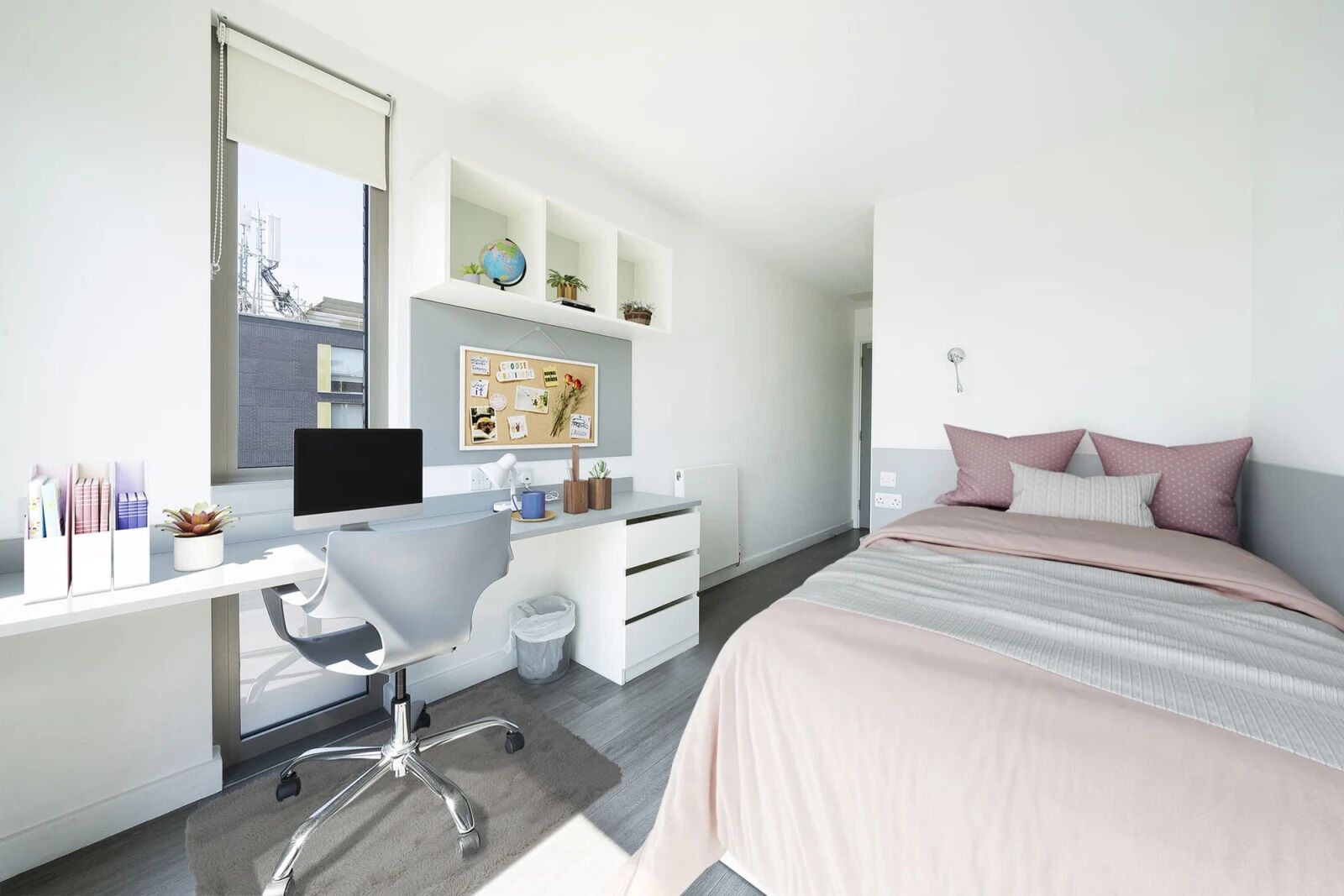 A modern bedroom with a desk, chair, and bed.