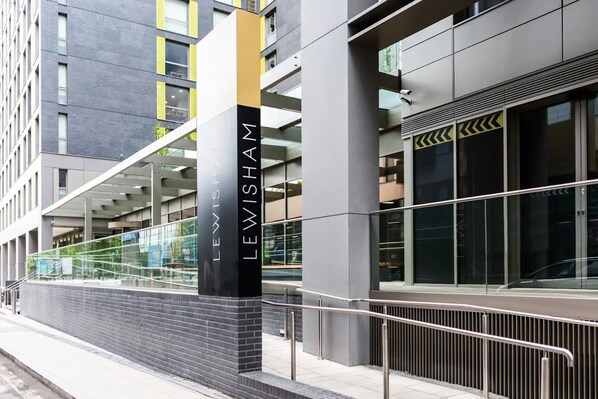 A modern building with a prominent 'LEWISHAM' sign, large windows, and a glass facade. - Chapter Lewisham in London - Campus Accommodation (London)