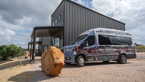 A modern building with a covered entrance and a large rock in front. - Waylon In The Hill Country - Hacienda Amor (Johnson City)