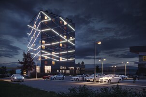 Un edificio moderno con fachada geométrica y varios espacios de estacionamiento.
