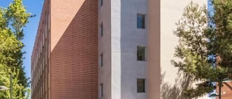 A B&B hotel with a modern design, featuring a prominent logo on the facade.