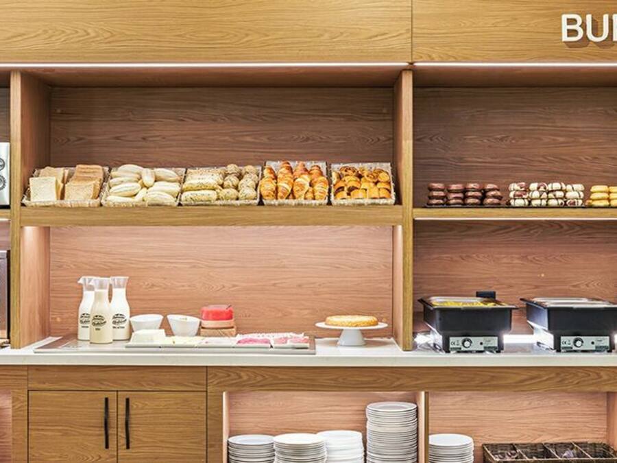 A buffet setup with various food items and kitchen appliances.