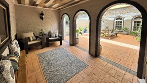 A cozy interior with a wooden ceiling, a patterned rug, and a seating area with a table and chairs. - Secluded Spiritual Oasis in Travelers Rest (Travelers Rest)