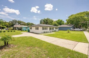 A single-story house with a front yard, a driveway, and a garage.