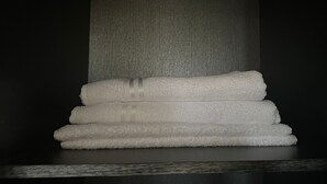 A stack of white towels on a dark surface. - Quiet apartment in downtown Agadir (Agadir)