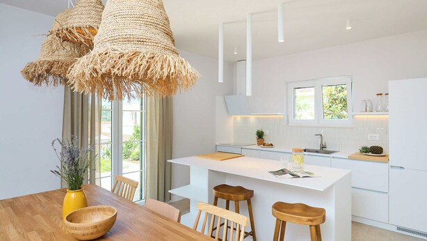 A modern kitchen with a central island, bar stools, and a wooden dining table. - Hedera Estate, Villa Hedera Xviii (Zupa dubrovacka)