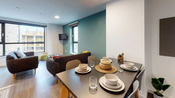 A modern living room with a dining area, large windows, and a flat-screen TV. - Student Only Canvas Walthamstow in London (London)