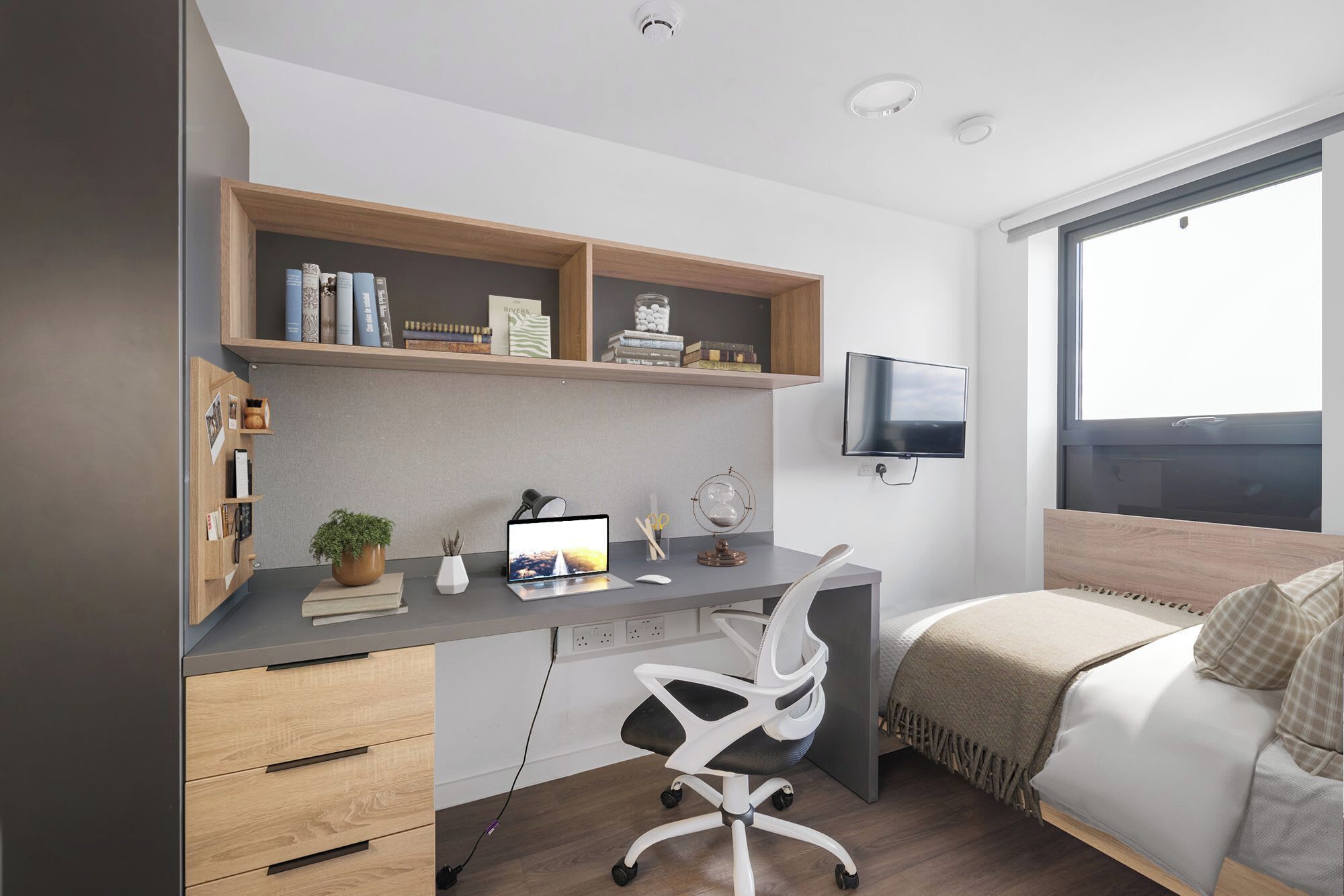A modern bedroom with a desk, a bed, a TV, and a large window.