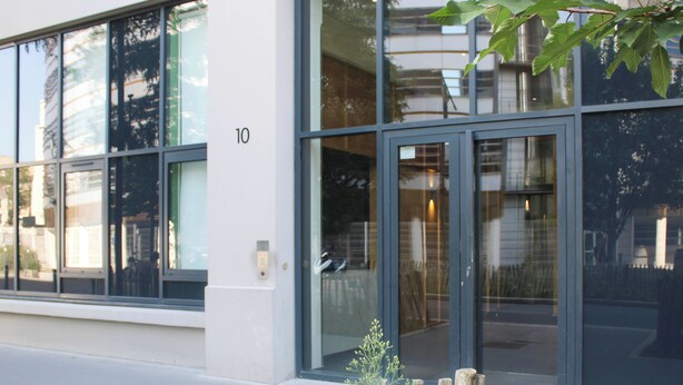 A modern building with large windows and a glass door entrance. - Stunning, Bright Duplex (Saint-Ouen-sur-Seine)