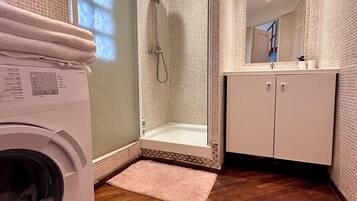 Shower, hair dryer, towels, toilet paper