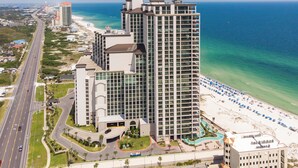 A high-rise hotel with multiple floors, a beachside location, and a swimming pool. - 1605 3bd Oasis Beach Paradise - OasisAtOrangeBeach (Orange Beach)
