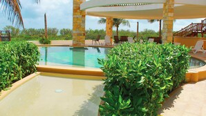 A pool area with lounge chairs and a covered seating area. - Corcomoran Luxury Beachfront house (Telchac Puerto)
