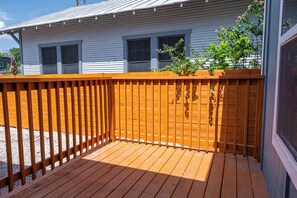 Guests can enjoy a deck with a railing, offering a view of the surrounding area.