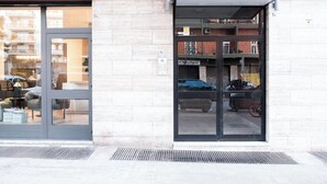 A building entrance with a glass door and a small awning.