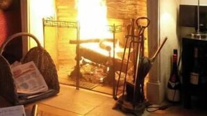 A living room with a fireplace, a statue, and a mirror. - House in Beaujolais village (Régnié-Durette)