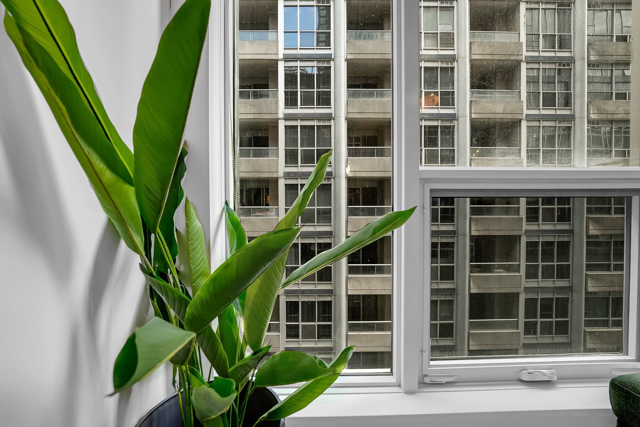 A view of a building with multiple balconies and a large window.