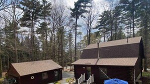 A cabin with a fire pit and outdoor seating area surrounded by trees. - Cozy Fishing and Get-A-Way Cabin minutes from Lake George (Kattskill Bay)