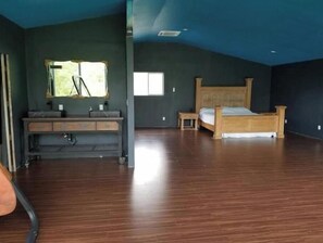 Relax in this serene room with a large bed, bench, and convenient storage.