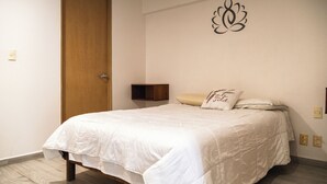 A bedroom with a bed, a wooden door, a wall-mounted shelf, and a decorative wall piece. - New Apartment City Oasis In Roma Norte (Mexico City)