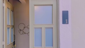 A door with frosted glass panels and a number '1' sign on the wall. - Beautiful double suite in an old house with contemporary restoration.  (Heroica Puebla de Zaragoza)