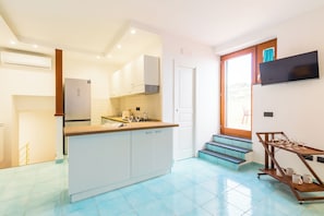 Apartment, Sea View | Living area | 30-inch flat-screen TV with digital channels