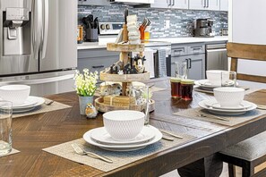 Enjoy cooking in this well-equipped kitchen with a refrigerator, stove, and coffee machine.