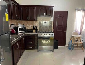 Private kitchen - Cozy 3-bedroom apartment with WiFi, in Bani pet friendly (El Llano)