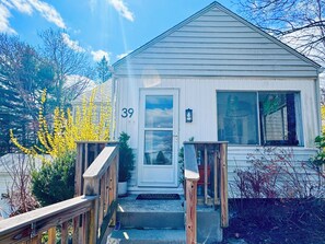 A single-story building with a front door, a small porch, and a number '39' on the door.