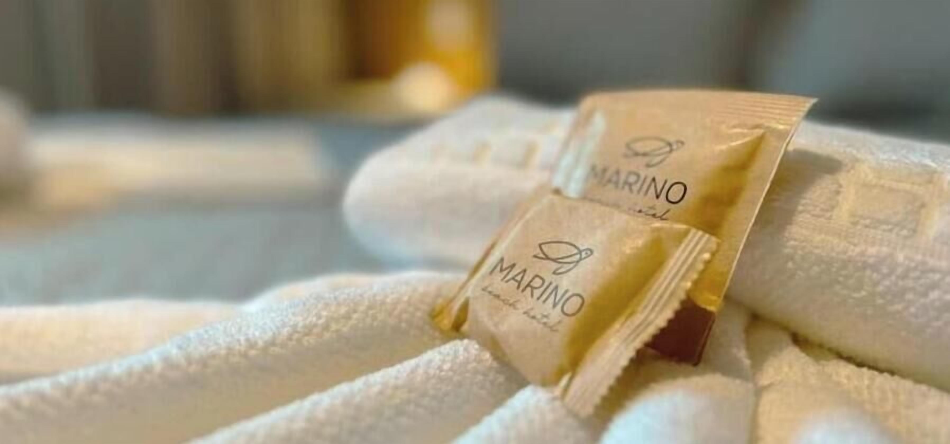 A towel with a MARINO branded towel bar.