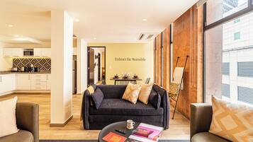 Grand Apartment, City View | Living area | 50-inch Smart TV with cable channels, streaming services