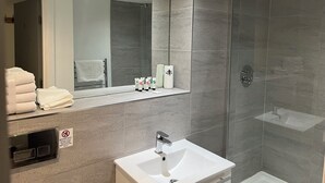 A modern bathroom with a glass-enclosed shower, a sink, and a mirror. - Location, Location, city centre apartment, 2 bedrooms, 2 bathrooms (Liverpool)