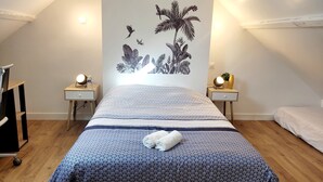 A bedroom with a bed, two bedside tables with lamps, a wall mural, and a wooden floor. - House 4 Bdrms and Terrace, Garden near. Sea, Golfs, Salt marshes, Walks (Guérande)
