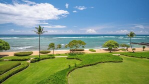 A golf course with a view of the ocean and palm trees.