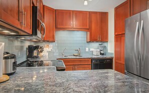 Fridge, stovetop, dishwasher, coffee/tea maker