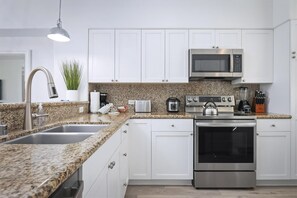 Fridge, stovetop, dishwasher, coffee/tea maker