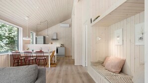 A modern interior with a dining area, kitchen, and seating space. - 3 bedroom amazing home in Nykøbing Sj (Nykøbing Sj)