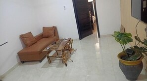 Relax in this inviting living room with a sofa, coffee table, and lush greenery.