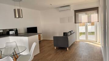 Deluxe Villa, Pool View | Living area | 42-inch Smart TV with cable channels