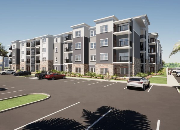 A multi-story residential building with balconies, a parking lot, and a landscaped area with palm trees. - Landing Apartments near North Fort Myers (North Fort Myers)
