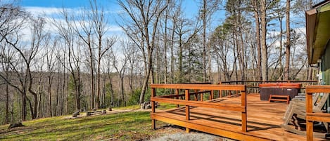 Eine Holzterrasse mit Sitzgelegenheit, umgeben von Bäumen.