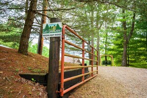 A gated entrance to Lazy Lane Cabins with a sign indicating the location.